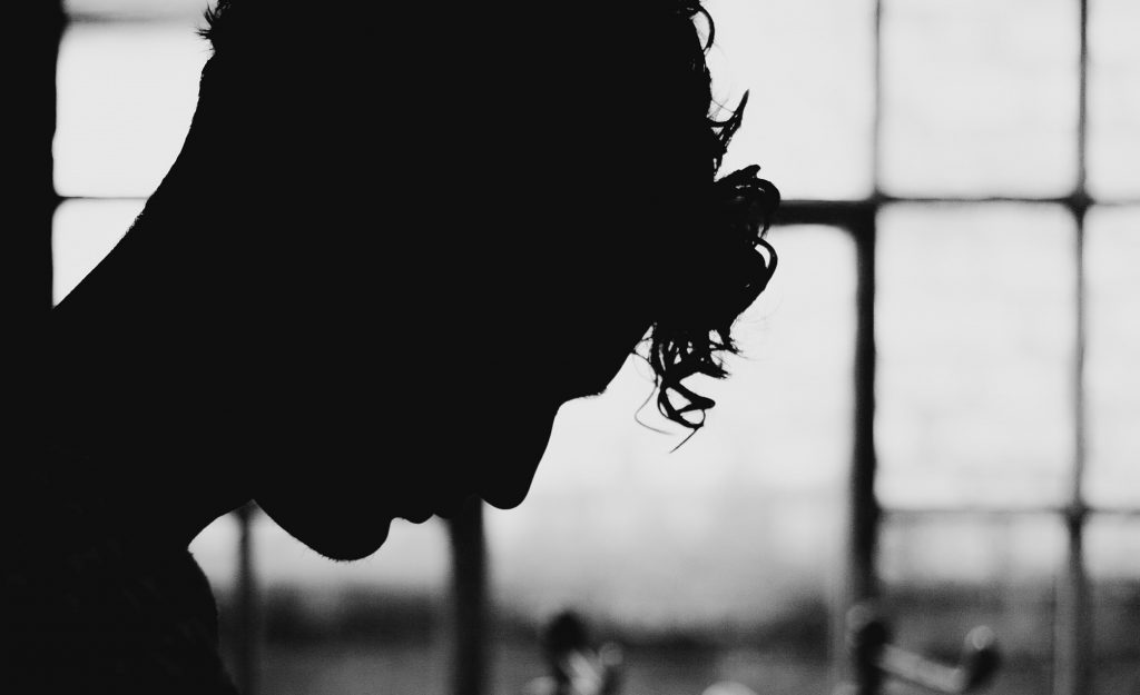 Man in front of window
