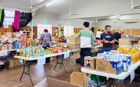 Tables with piles of food items.