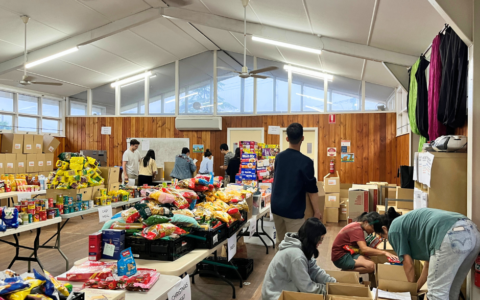 Lots of people packing hampers full of food.