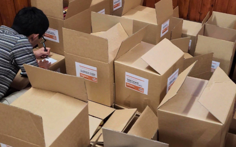 A man checking cardboard boxes